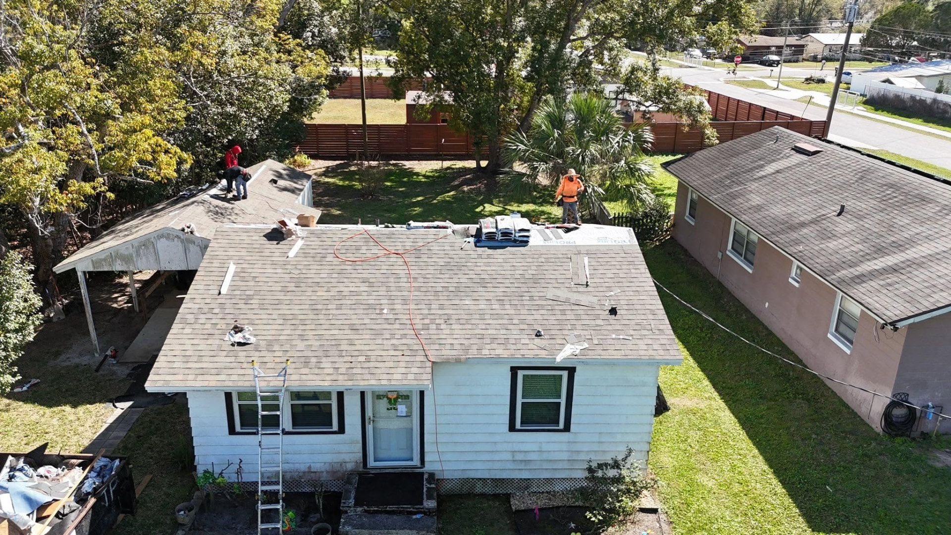 Best Buy Roofing crew tearing off an old roof on a Florida home